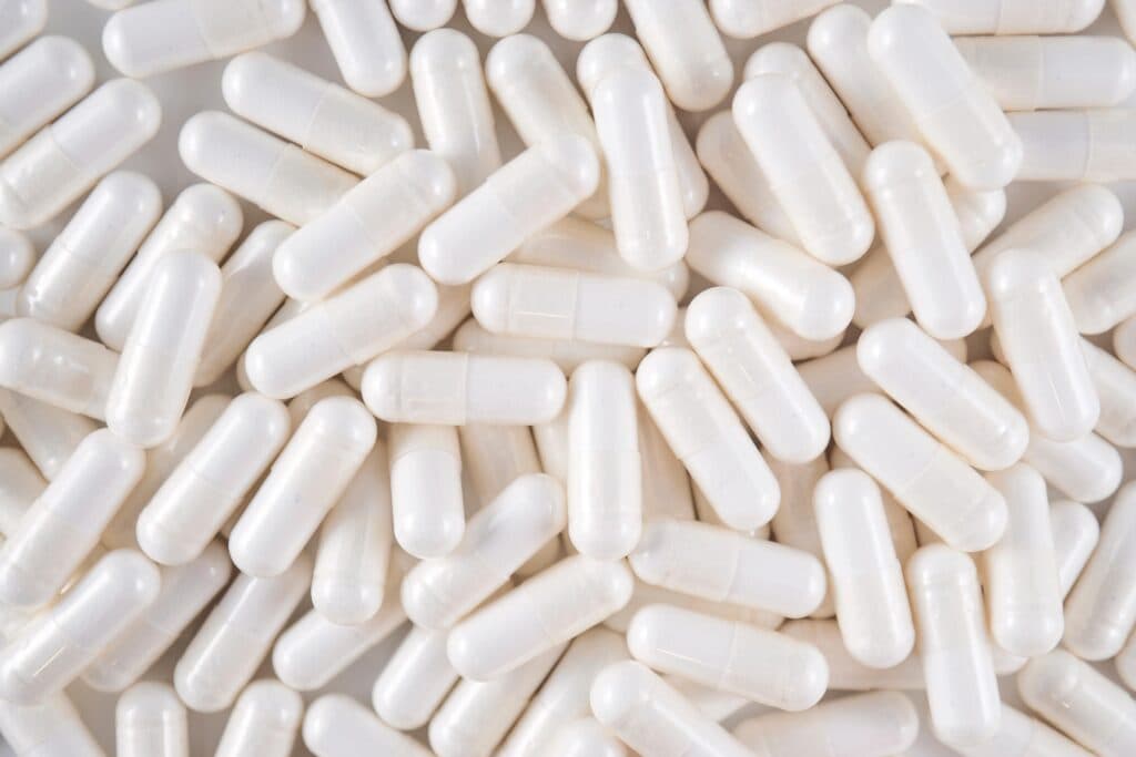 a pile of white capsules