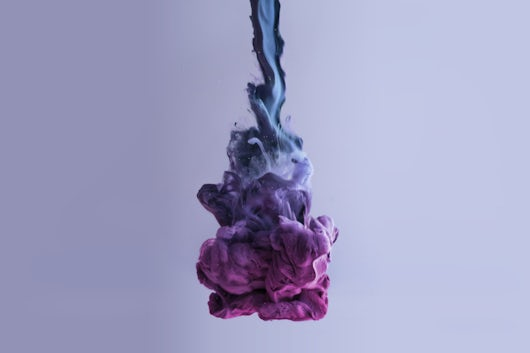 closeup of colorful chemical dissolving in liquid