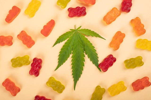 colorful cbd gummies against a yellow background