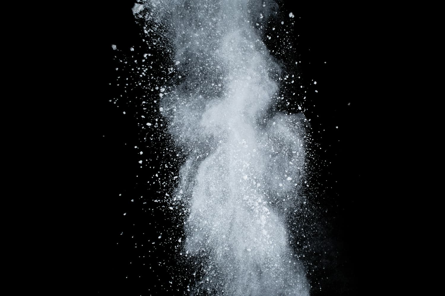 white powder scattering against black background