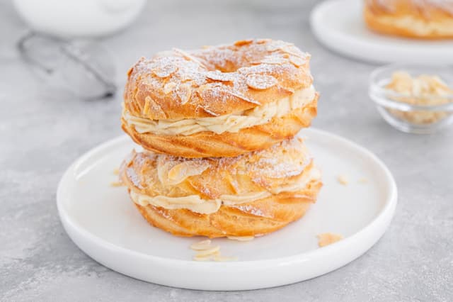 two pastries filled with cream on a white plate
