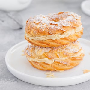 two pastries filled with cream on a white plate