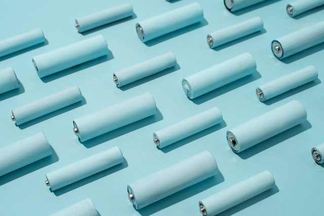 top view of batteries in rows on light blue surface