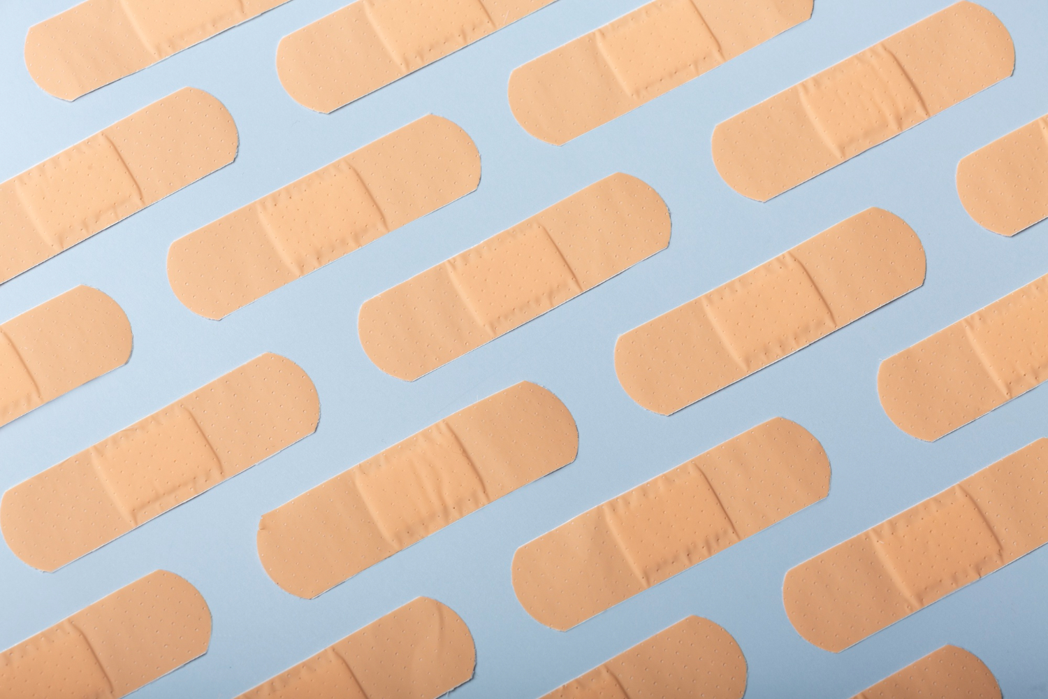 top view of plaster strips arranged diagonally on a blue surface