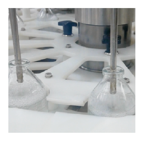 Rotary vial filling and stoppering system