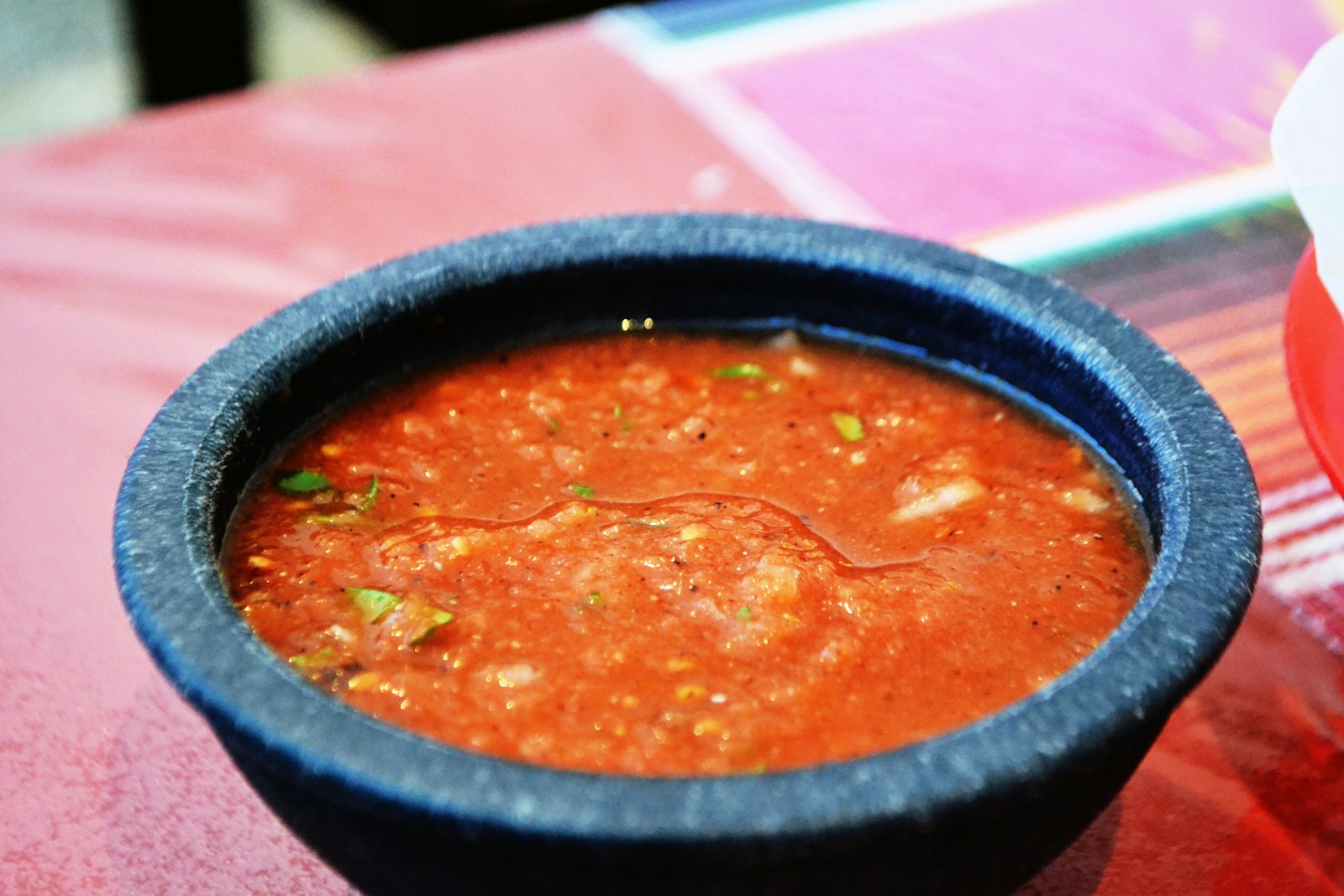 a bowl of soup sitting on top of a table