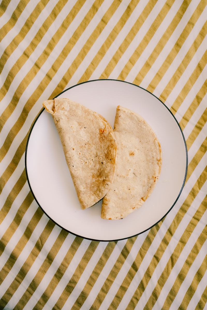 Two quesadillas sit on a white plate.