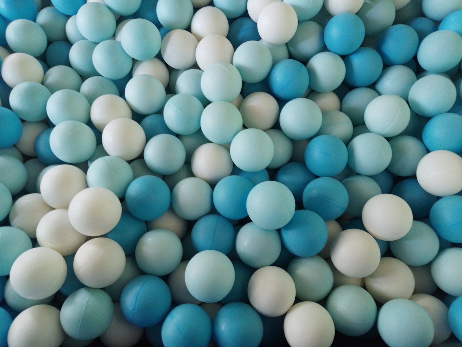 a pile of blue and white candy balls